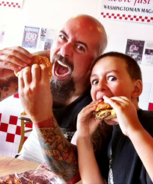 A father and son enjoying a meal at Five Guys