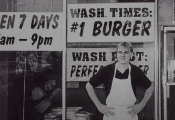 A person standing outside restaurant